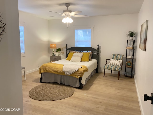 bedroom featuring ceiling fan, wood finished floors, and baseboards