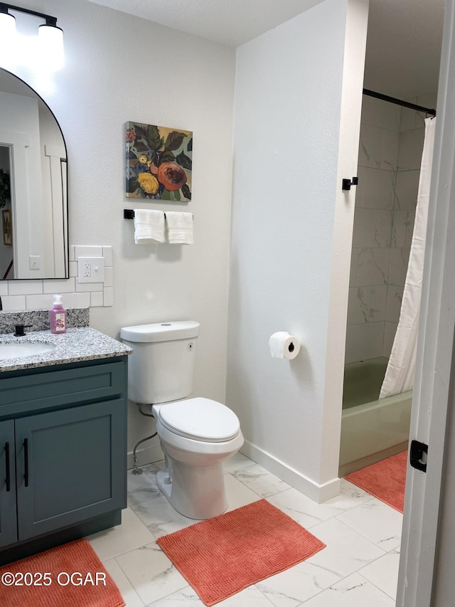 bathroom with baseboards, toilet, shower / tub combo with curtain, marble finish floor, and vanity