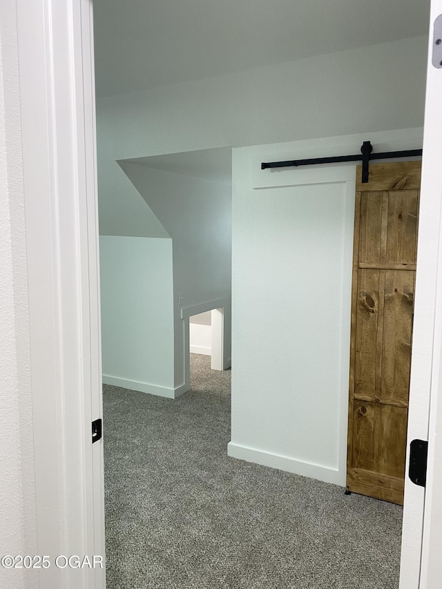 interior space with a barn door and baseboards