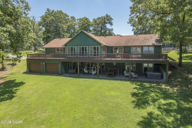 back of house with a garage, a patio, a yard, and a wooden deck