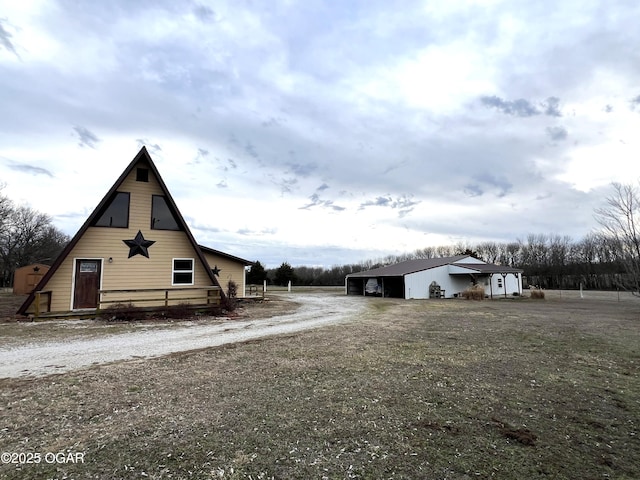 view of home's exterior with an outbuilding and driveway