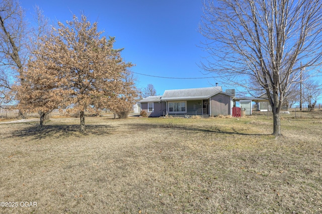 exterior space with covered porch and a front lawn