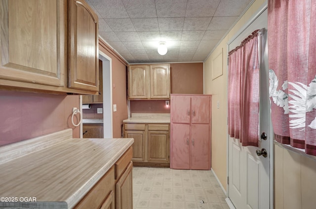 kitchen featuring light floors and light countertops