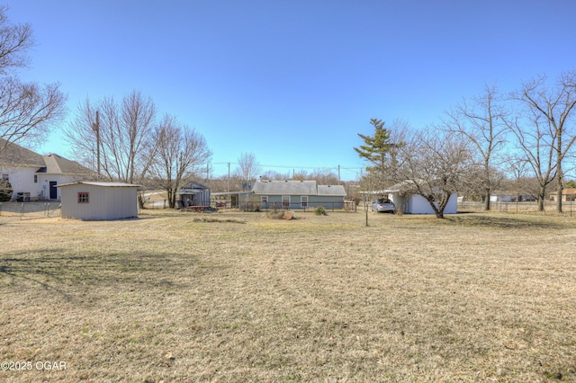 view of yard featuring an outbuilding and fence