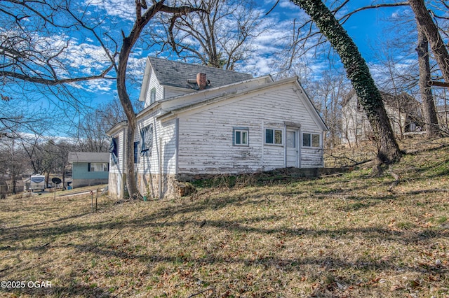 view of home's exterior with a yard