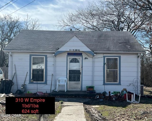 bungalow-style house featuring roof with shingles