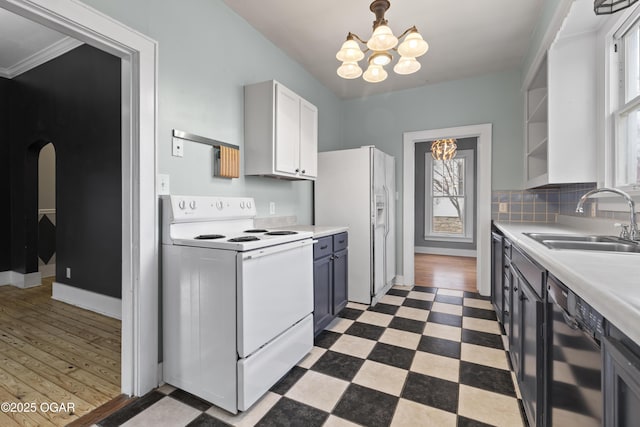 kitchen featuring a notable chandelier, open shelves, a sink, white appliances, and tile patterned floors