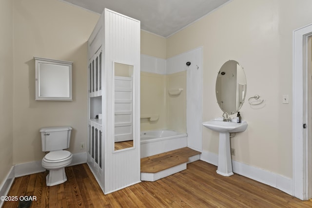 full bathroom with toilet, baseboards, tub / shower combination, and wood finished floors