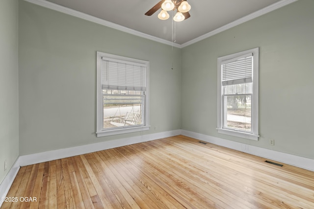 unfurnished room featuring visible vents, a ceiling fan, hardwood / wood-style flooring, and crown molding