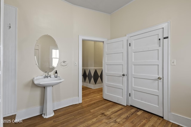 bathroom with baseboards and wood finished floors