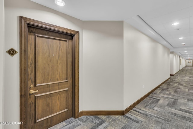 hallway with recessed lighting, carpet flooring, and baseboards