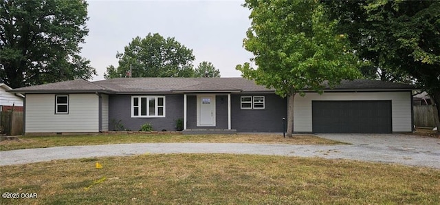 ranch-style house featuring a garage, a front yard, crawl space, and driveway