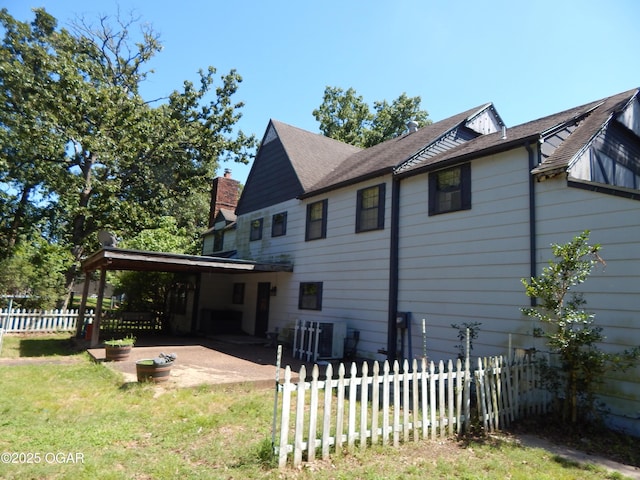 4415 Mcclelland Park Rd, Joplin, MO 64804 - back of property featuring a patio area and a chimney