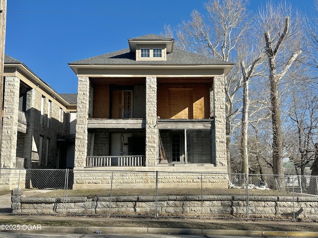 view of front of house featuring a fenced front yard and a shingled roof