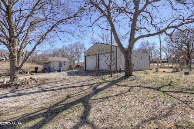 exterior space featuring a garage and an outdoor structure