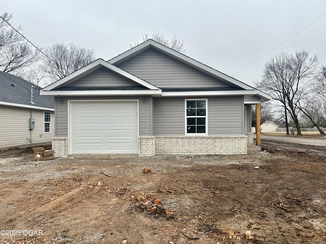 view of front of property with a garage and brick siding