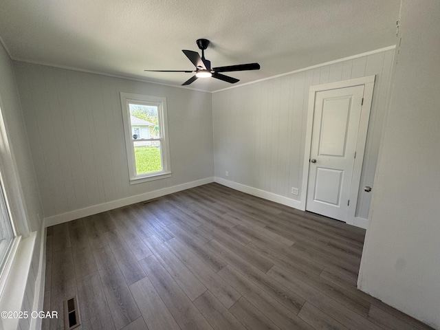 1711 Missouri Ave, Joplin, MO 64804 - empty room featuring a ceiling fan, dark wood-type flooring, baseboards, crown molding, and a textured ceiling