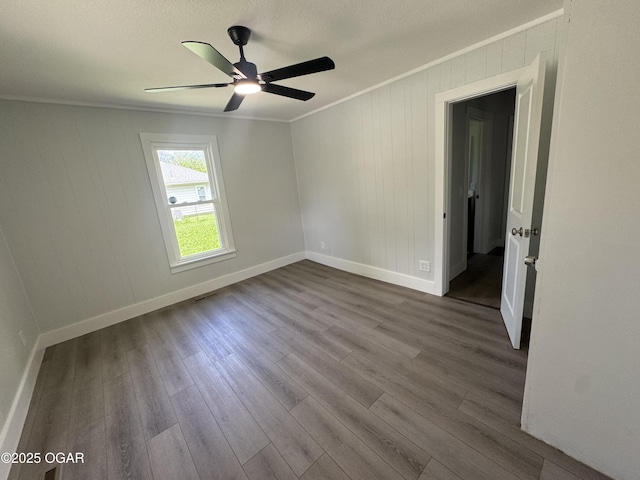 1711 Missouri Ave, Joplin, MO 64804 - unfurnished room featuring ornamental molding, baseboards, a ceiling fan, dark wood-style flooring, and a textured ceiling