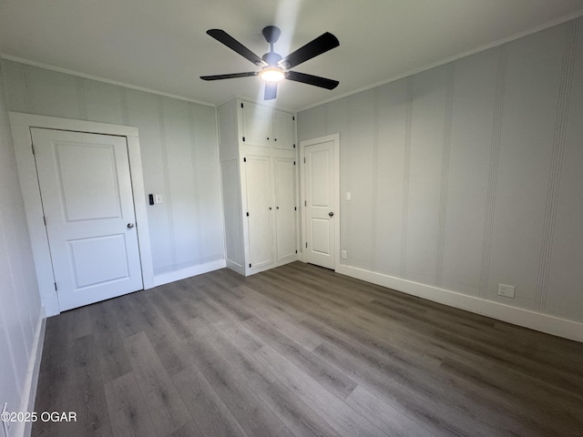 1711 Missouri Ave, Joplin, MO 64804 - unfurnished bedroom with dark wood-type flooring, ornamental molding, a decorative wall, baseboards, and a ceiling fan