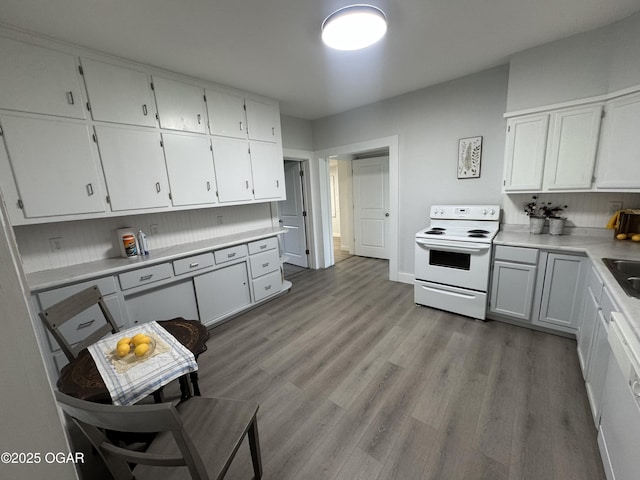 1711 Missouri Ave, Joplin, MO 64804 - kitchen featuring white appliances, white cabinetry, and light wood-style floors
