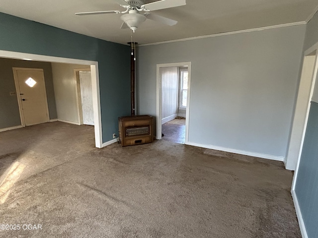 unfurnished living room featuring ornamental molding, ceiling fan, carpet floors, and baseboards