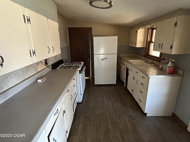 kitchen with white appliances, dark wood-style flooring, light countertops, white cabinetry, and a sink