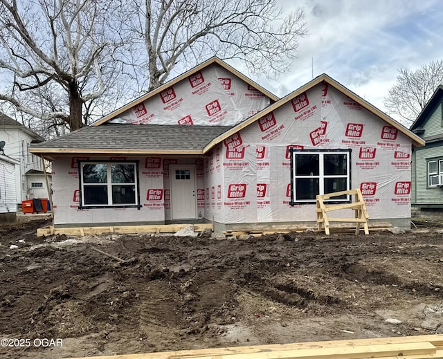 property under construction with roof with shingles