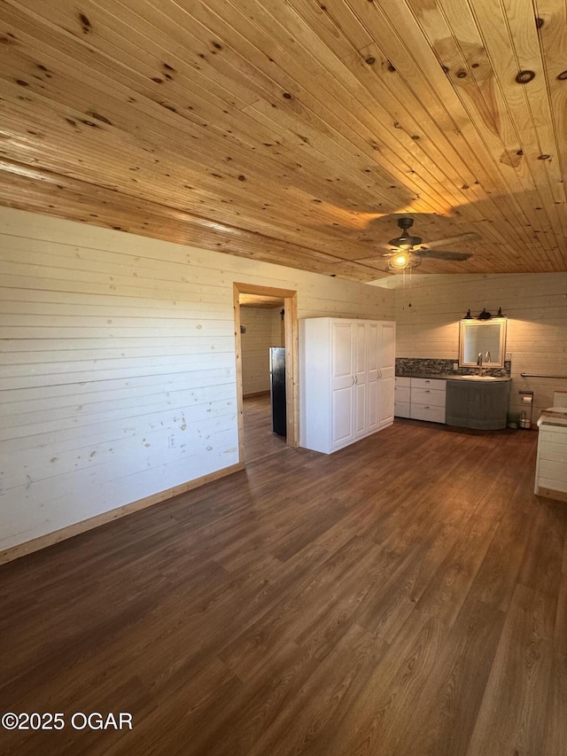 unfurnished bedroom with dark wood-style floors, wooden ceiling, and a sink