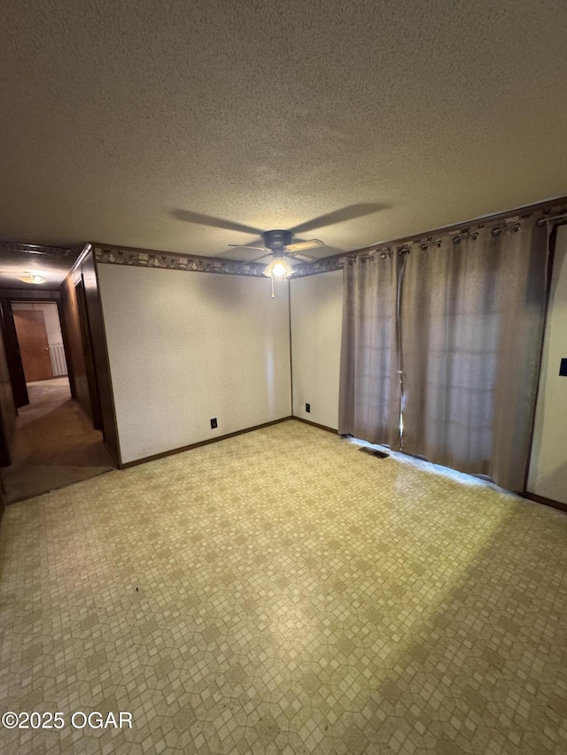 spare room featuring a ceiling fan and a textured ceiling