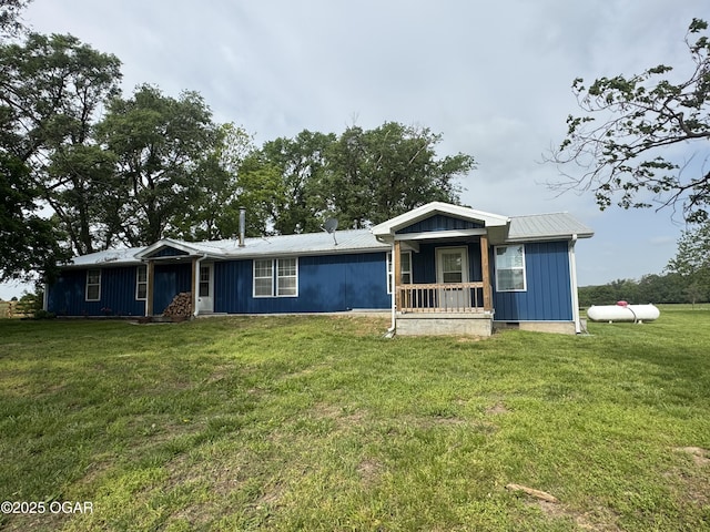 19410 Urchin Dr, Stella, MO 64867 - view of front of property featuring a front yard, metal roof, covered porch, and board and batten siding