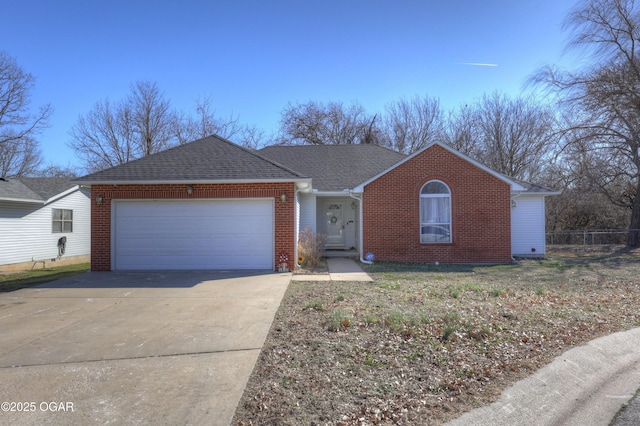 ranch-style home featuring driveway, brick siding, roof with shingles, and an attached garage