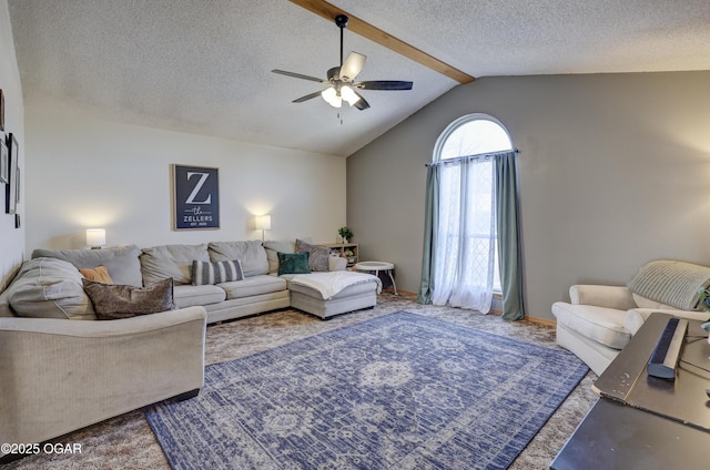 carpeted living room featuring ceiling fan, lofted ceiling with beams, and a textured ceiling