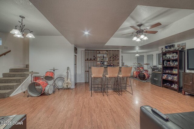 107 Oak Leaf Ter, Joplin, MO 64804 - dining space with stairs, a textured ceiling, a dry bar, and wood finished floors