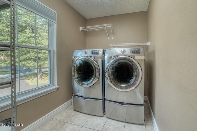 107 Oak Leaf Ter, Joplin, MO 64804 - laundry area with a textured ceiling, laundry area, independent washer and dryer, baseboards, and tile patterned floors