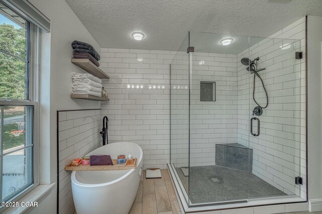 107 Oak Leaf Ter, Joplin, MO 64804 - bathroom with a stall shower, a freestanding tub, a wealth of natural light, and wood finished floors