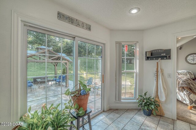 107 Oak Leaf Ter, Joplin, MO 64804 - doorway to outside featuring a textured ceiling and baseboards