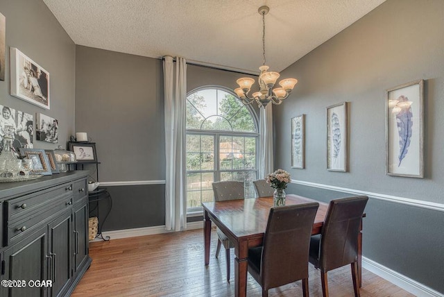107 Oak Leaf Ter, Joplin, MO 64804 - dining room featuring light wood-style floors, baseboards, and an inviting chandelier