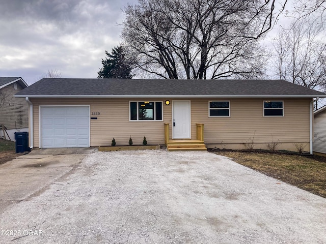 ranch-style house with a garage, a shingled roof, and concrete driveway