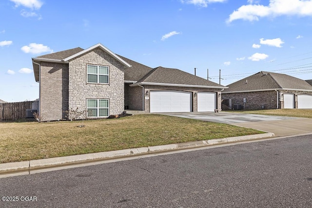 view of front of home featuring a garage, a shingled roof, concrete driveway, fence, and a front lawn