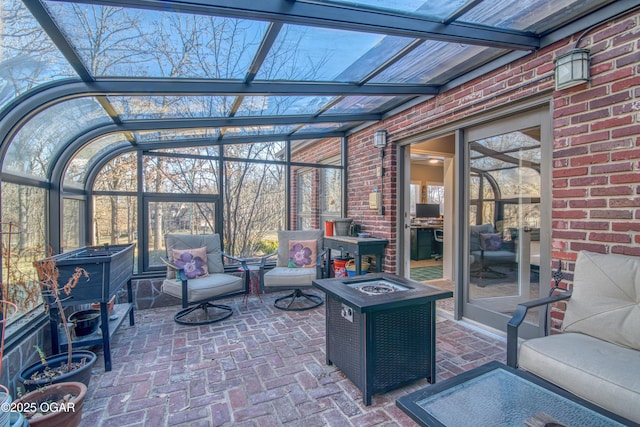 unfurnished sunroom featuring a wood stove