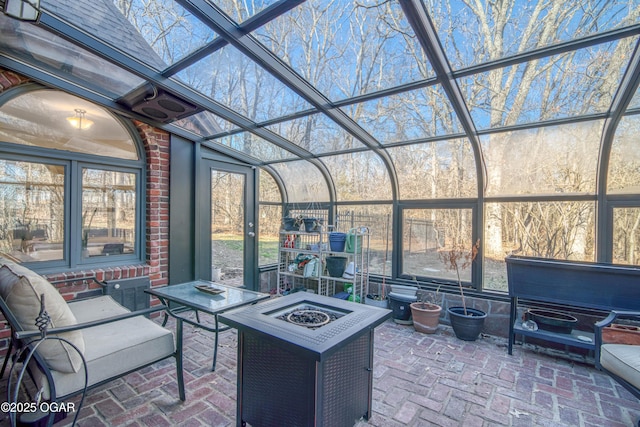 view of patio with a lanai and an outdoor fire pit