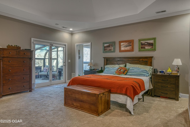 carpeted bedroom with access to outside, a high ceiling, visible vents, and crown molding