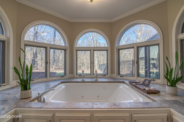 bathroom with a tub with jets and ornamental molding