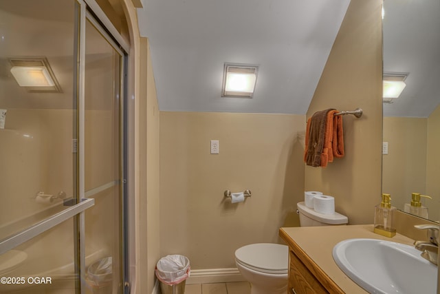 bathroom featuring a stall shower, toilet, tile patterned flooring, vaulted ceiling, and vanity