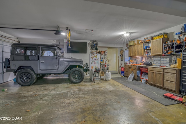 garage with a workshop area and concrete block wall