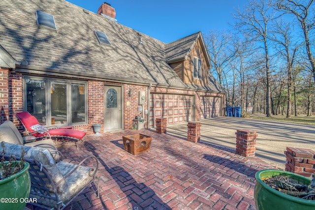 view of patio with decorative driveway and an attached garage