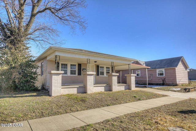 view of front of home with covered porch and stucco siding