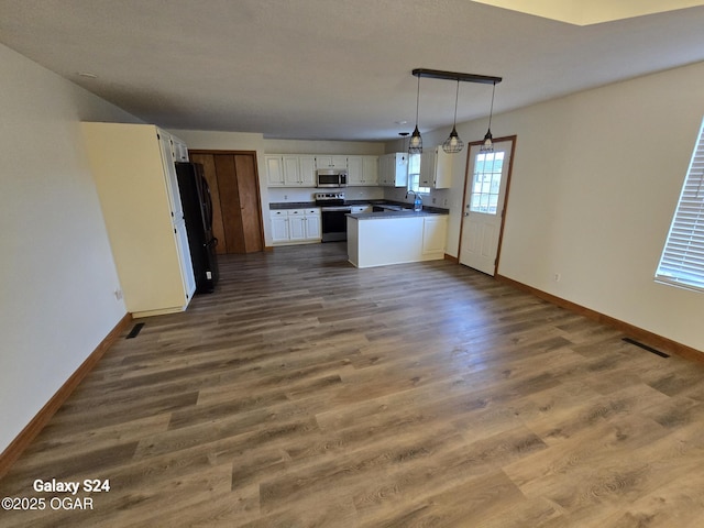 kitchen with baseboards, white cabinetry, appliances with stainless steel finishes, and dark wood-style flooring