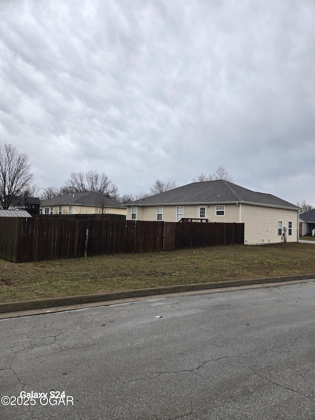 view of home's exterior with fence