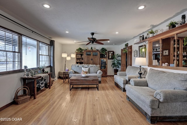 living room with recessed lighting, ceiling fan, baseboards, and light wood-type flooring